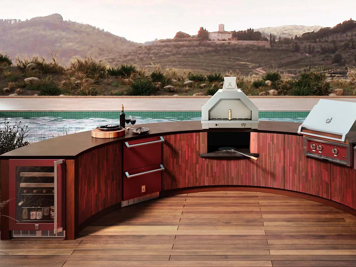 A gas-fired pizza oven built into a curved outdoor kitchen island alongside a grill